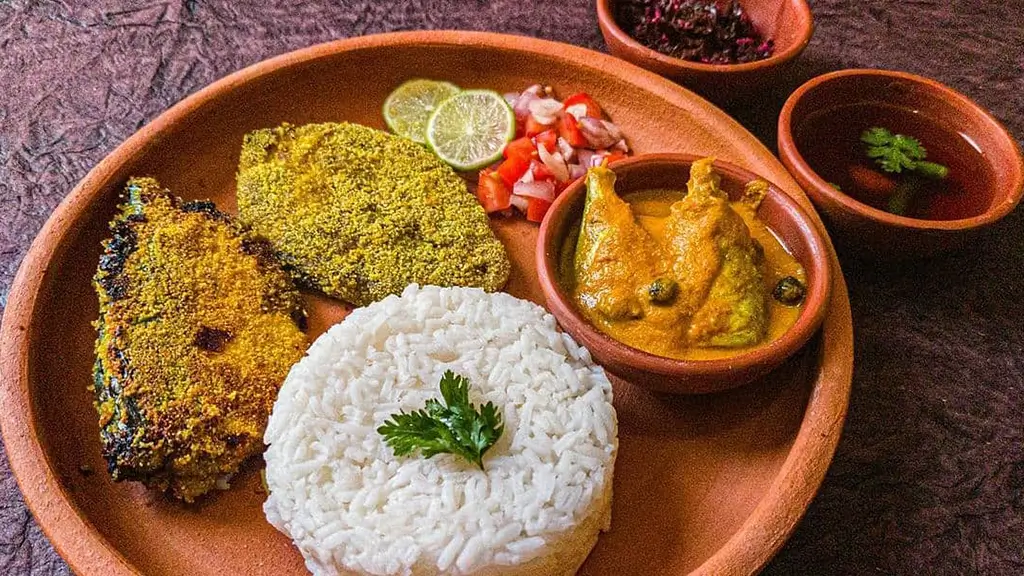 Fish thali containing kingfish, mackeral and its curry, salad, white rice and sol curry
